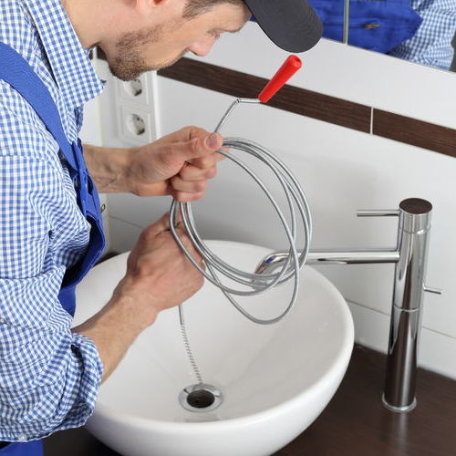 Drain cleaning of a bathroom sink.